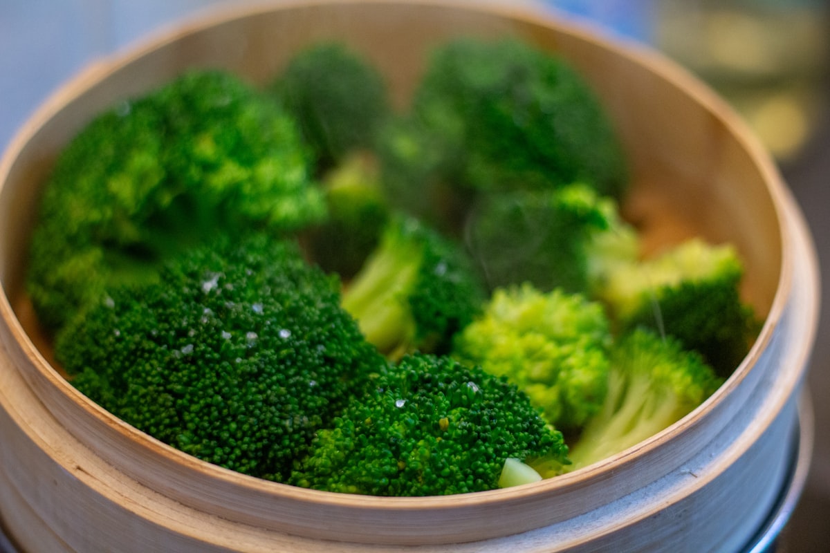 Fresh vegetables being steamed in a pot